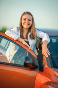 New driver poses proudly with her new car