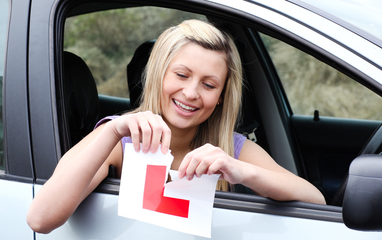 Learner driver tearing up L Plate after passing driving exam