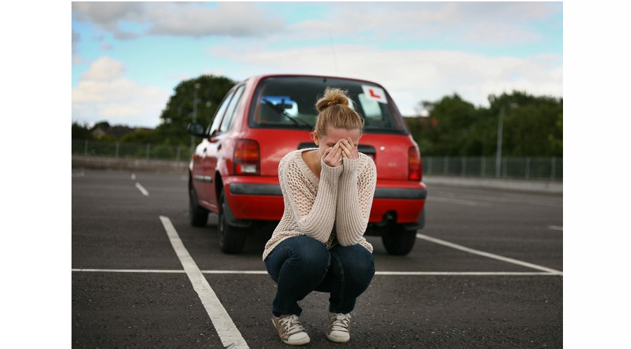 Woman crying outside learner car