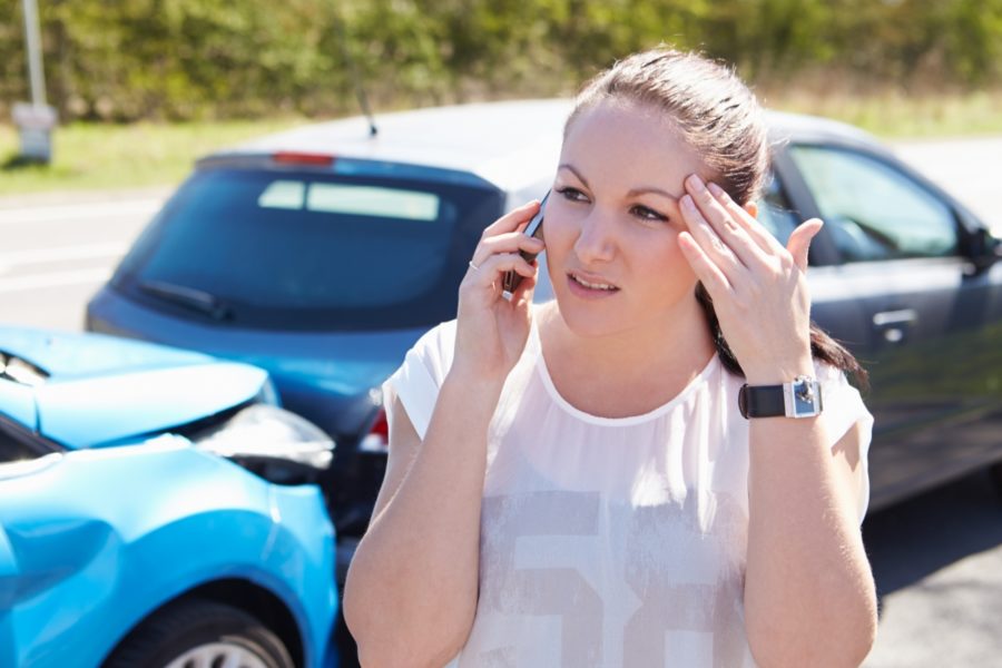 Girl on the phone after a car accident