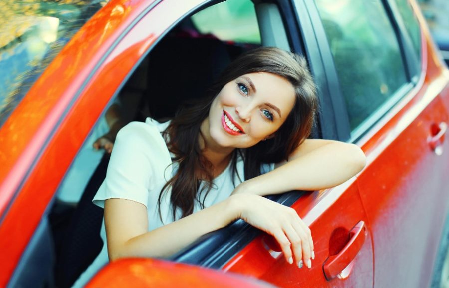 woman in red car