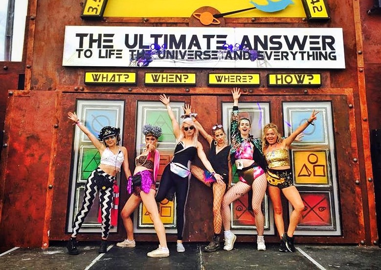 Group of women at a festival with gold outfits