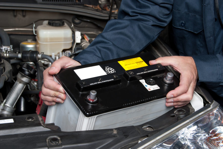 Mechanic changing a car battery