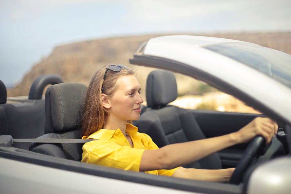 woman driving convertible car